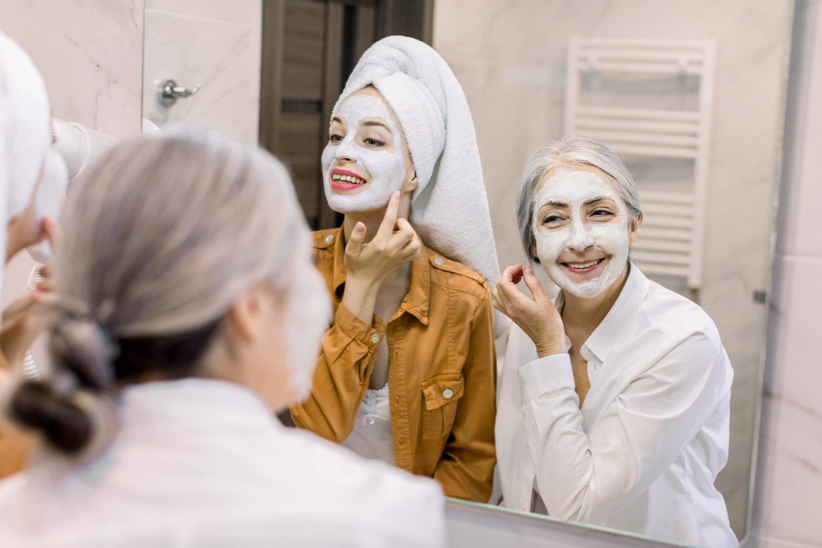 mom and daughter in mirror with facemasks