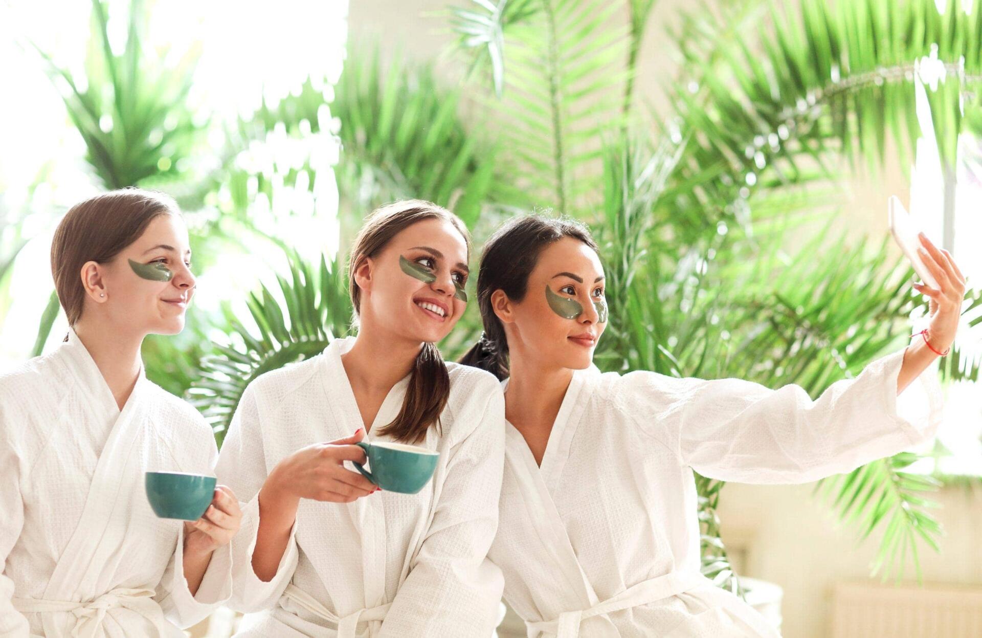 smiling women taking photo in spa salon