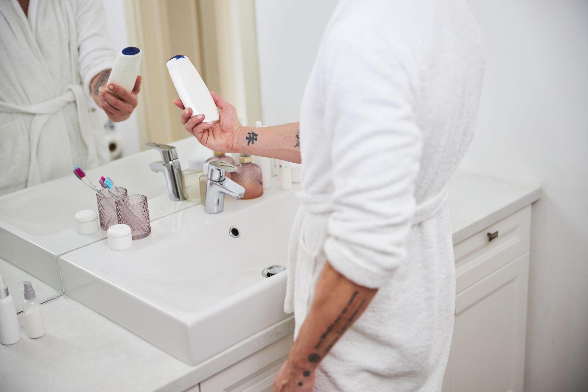 strong male in front of the mirror in bathroom