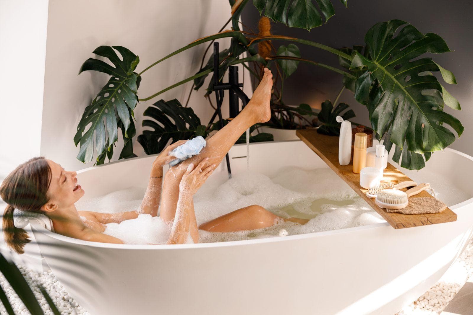 side view of young woman bathing and taking care of her skin at luxury spa resort