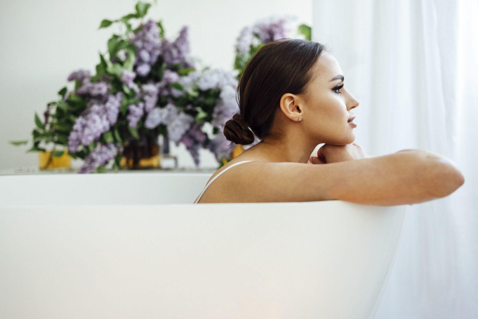 woman folding arms on a hot tub and placing her chin on them whi