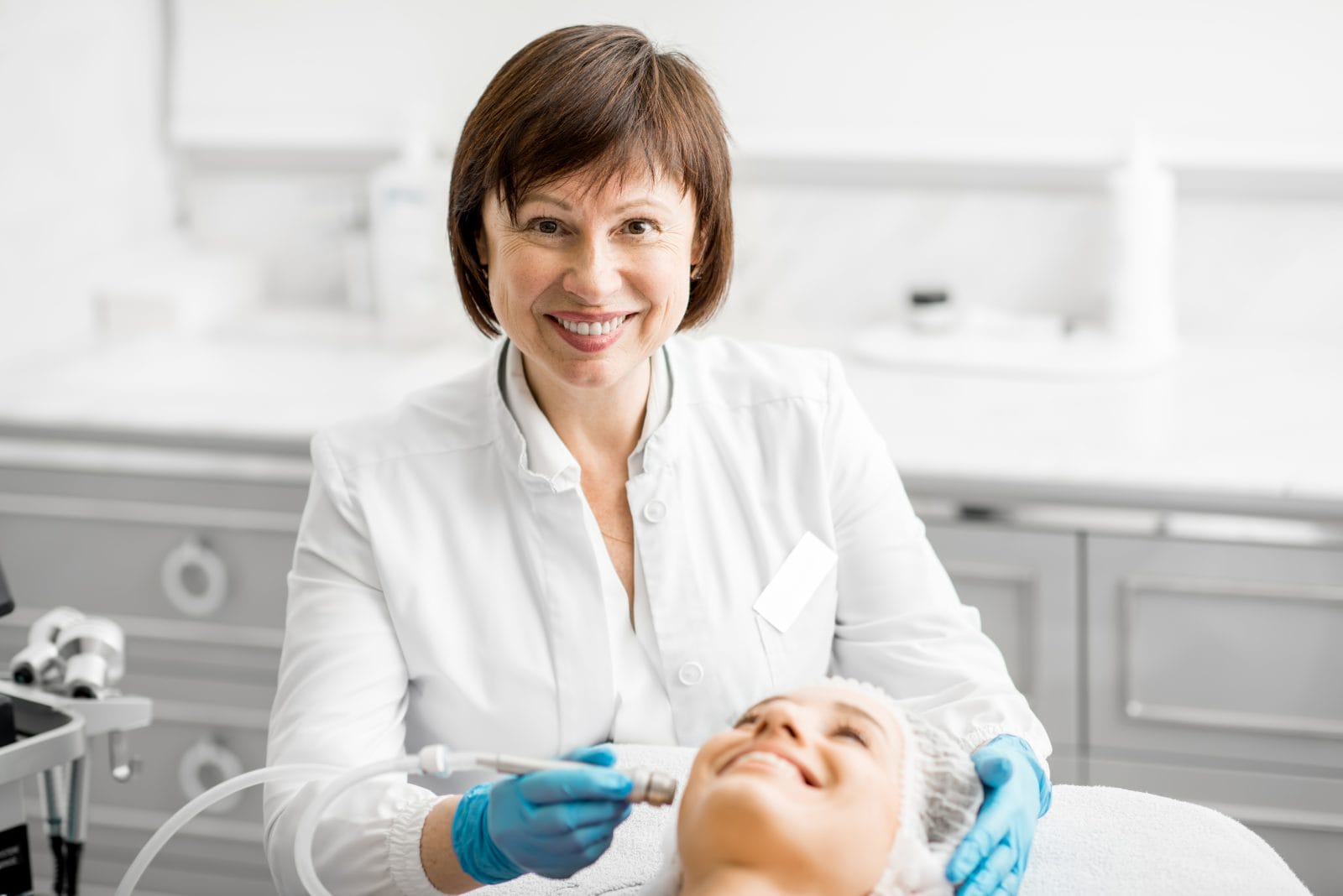 senior woman cosmetologist during the procedure