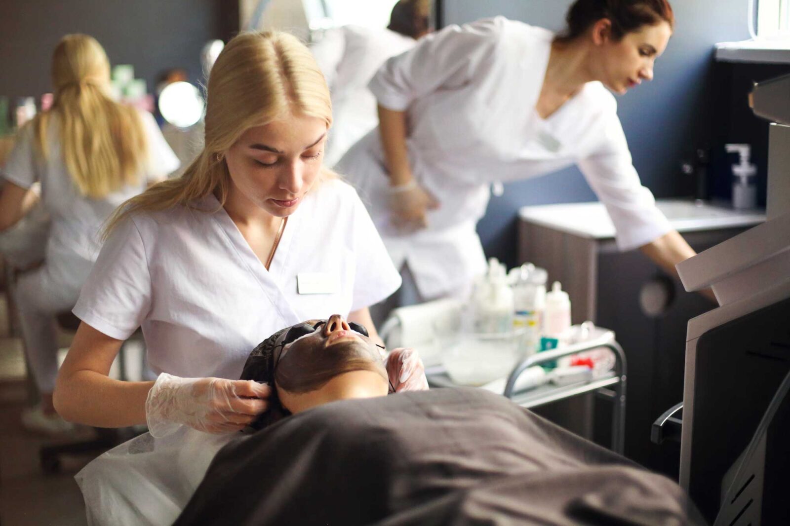 cosmetologist applying black mask on the face of a 2025 01 09 22 03 53 utc